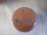 a brown vase that has writing on it on a table