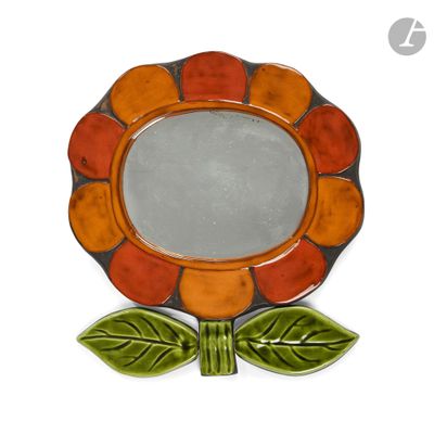 a small decorative mirror with a flower on it