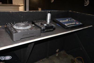 two turntables sitting on top of a shelf in a room