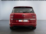 the rear end of a red citrole parked in a garage