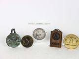 several different types of coins are displayed on a white surface