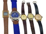 several different types of watches are lined up on a white surface