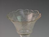 a glass vase with a flower inside of it on a table