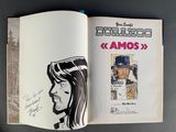 an open book with a drawing of a man wearing a hat