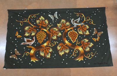 an image of a black table cloth with a design of birds and flowers