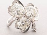 an image of a diamond ring with a four leaf clover design
