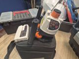 a black suitcase with a cell phone on top of it
