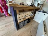 a room with a desk, shelves, and a chair in it