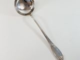 a silver spoon with a spoon handle on a white surface