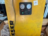 a yellow machine that is sitting on a pallet