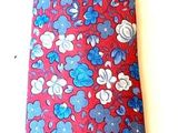 a red tie with blue and white flowers on it