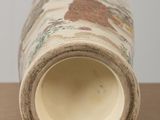 a close up of a vase on a table