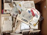a cardboard box full of old postcards and postcards