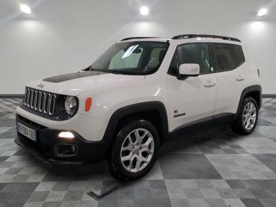 the white jeep renegade is parked in a large room