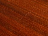 a close up of a wooden table with a clock on it