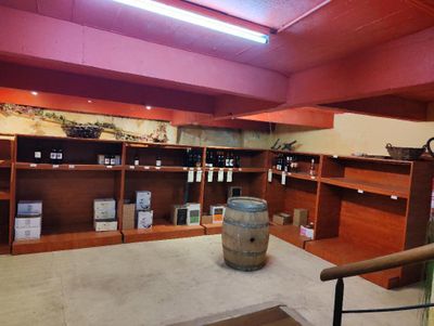 a wine shop with a barrel of wine on the counter