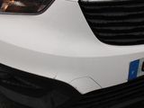 a close up of a white car parked on the street