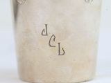 a silver cup with writing on it sitting on a table