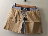 a picture of a tan skirt hanging on a wall