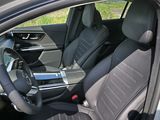 the interior of a car with a steering wheel and a phone in the passenger seat