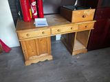 a wooden desk with a fire extinguisor on top of it