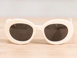sunglasses on a wooden table with a white background