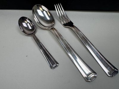 three spoons and two spoons sitting on a table