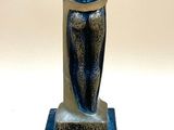 statue of a woman holding a child on a marble base