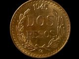 a close up of a gold coin on a black background