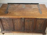 a wooden chest sitting on a tile floor in a room