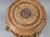 a wooden table with a circular design on top of it