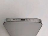 the back of a silver cell phone with a small hole in the middle of it