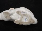 porcelain figurine of a cat with a tag on it ' s face