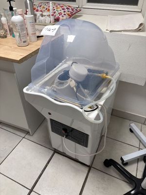 a sink with a plastic cover on it in a bathroom