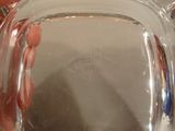 a person holding a clear glass pitcher in their hand