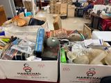 two boxes of stuff sitting on a table in a room