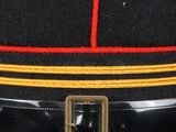 a black hat with a red and yellow stripe on it