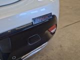 a close up of a car ' s rear bumper with a clock on it