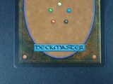 a picture of a deckmaster card with four different colored buttons