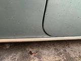 a small bug that is sitting on the side of a car