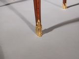 an antique wooden table with a marble top and gold legs