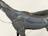 a statue of a horse with a saddle on it ' s back