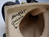 a close up of a vase with writing on it