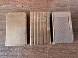 three different types of lighters sitting on top of a wooden table