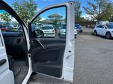 a white van with its door open in a parking lot
