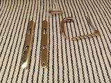 a pair of brass door handles on a striped carpet