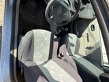 the interior of a car with the door open and the driver ' s seat up