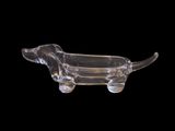 clear glass dachshund dog figurine on a black background