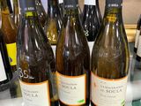 several bottles of wine are lined up on a counter