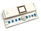 a box with a watch inside of it on a white surface